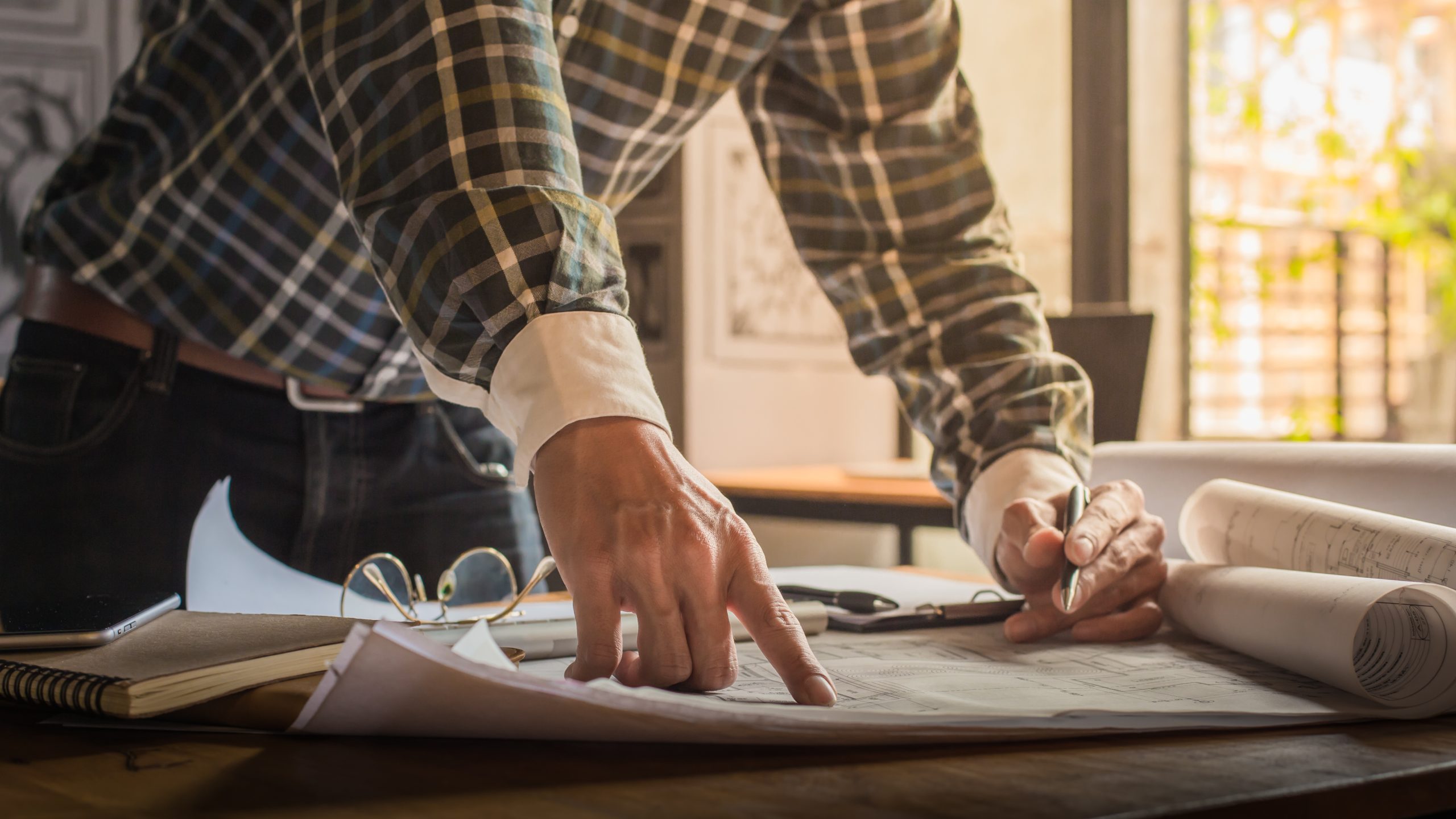 creative architect projecting big drawings dark loft office cafe with dark retro style scaled